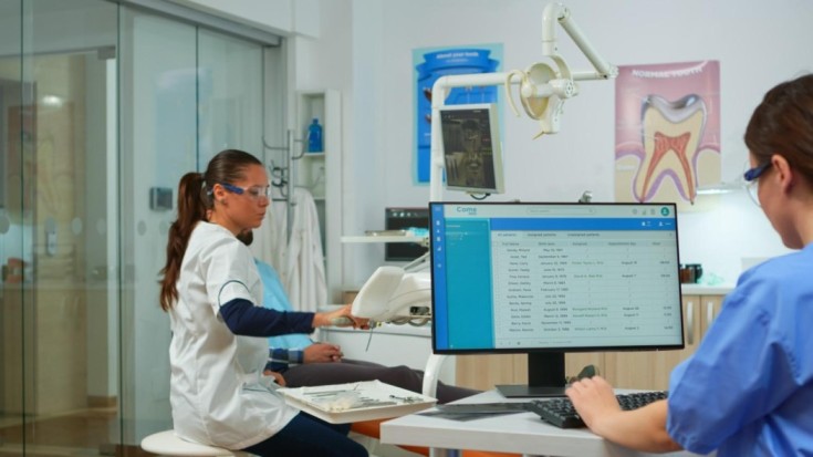 1749553927-nurse-typing-computer-making-appointments-while-dental-specialist-talking-patient-stomatology-chair-before-examination-dentist-nurse-working-together-modern-stomatological-clinic3_(1)_(1).jpg