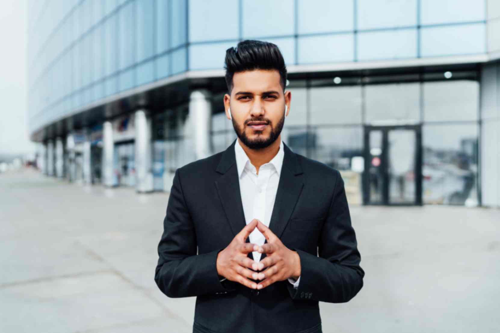 1753075332-jpeg-optimizer_portrait-serious-smiling-modern-indian-man-near-office-building.jpg