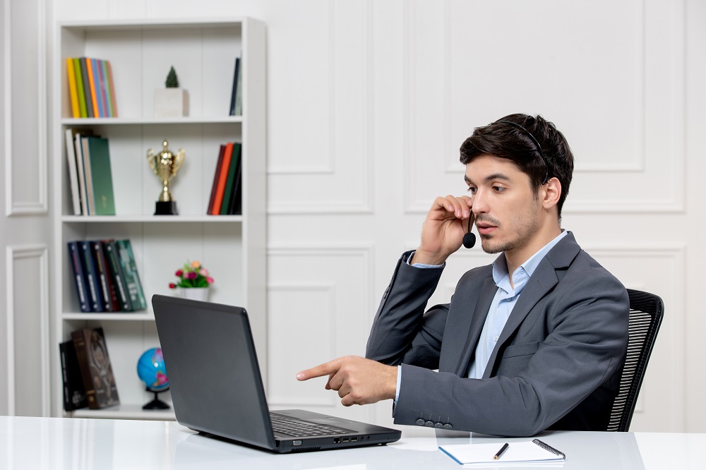 1753163918-customer-service-cute-guy-grey-suit-with-computer-headset-pointing-screen.jpg