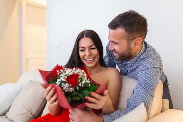 1753779480-excited-young-woman-receiving-unexpected-bouquet-red-roses-from-husband-home-loving-generous-boyfriend-making-romantic-surprise-attractive-girlfriend-valentines-day-occasion_1212-9931.jpeg
