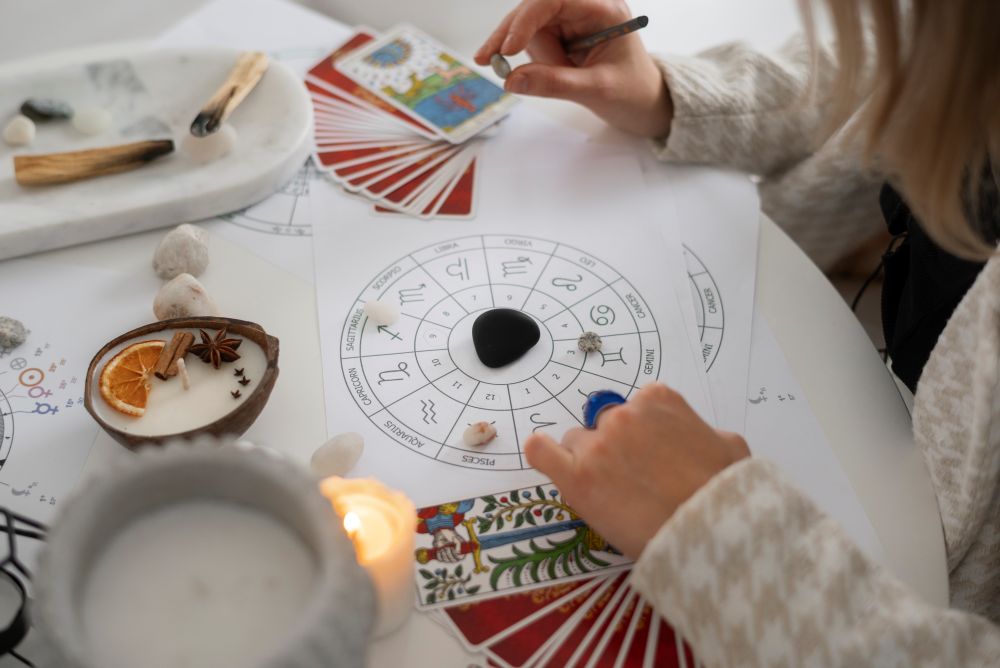 1755325805-high-angle-woman-reading-tarot-home.jpg