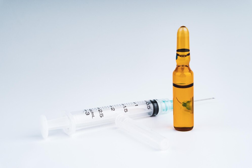 close-up-medicine-bottle-syringe-against-white-background_1048944-24631904.jpg