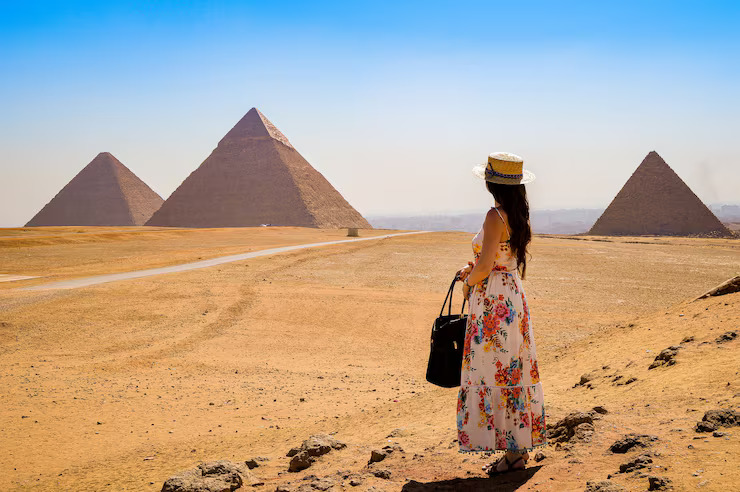 young-woman-visiting-pyramids-egypt_181624-45406_(1).jpg